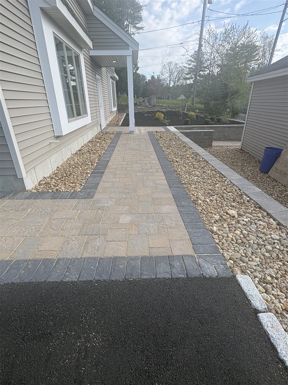 Paver entry walk with charcoal border and washed stone beds